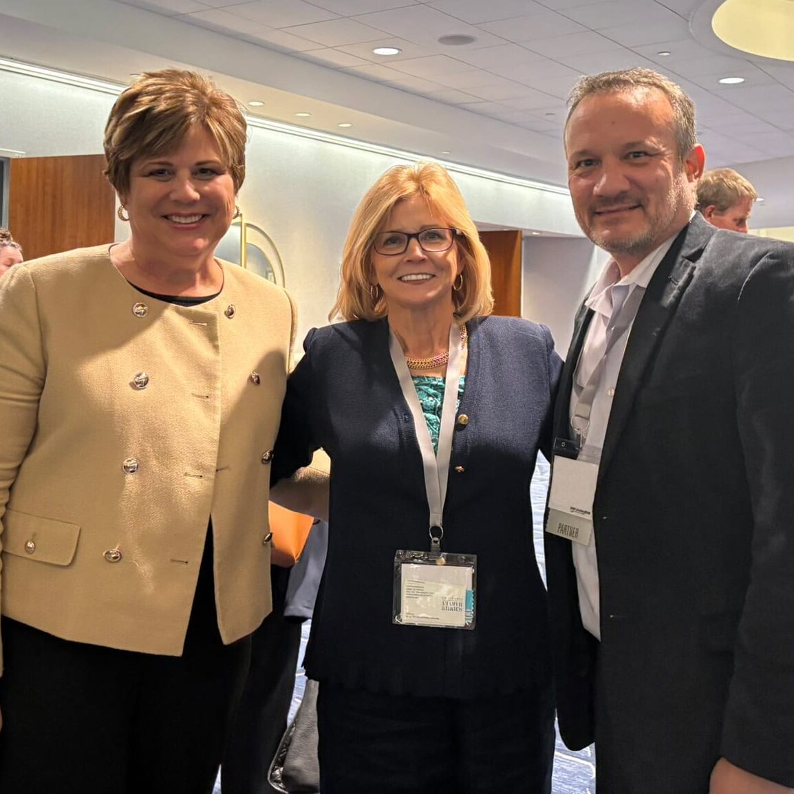 3 smiling attendees at the 2024 Leading Edge Consortium
